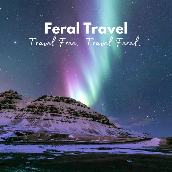 Iceland Image Northern lights over a snowy peak in Iceland research guide by Feral Travel